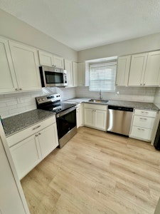 Brand new kitchen with new dishwasher, stove, and microwave