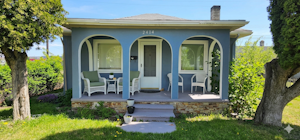 Bright covered front porch with afternoon sun perfect for relaxing