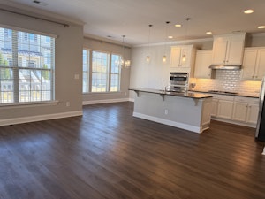 Bright, open-concept kitchen, dining, and living area with abundant natural light.