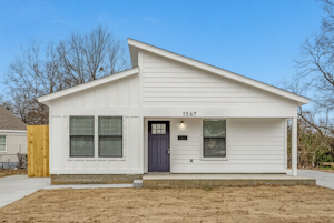 Modern townhouse featuring a well-kept exterior, private driveway, and secure entry—offering residents comfort and peace of mind.