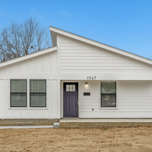 Modern townhouse featuring a well-kept exterior, private driveway, and secure entry—offering residents comfort and peace of mind.