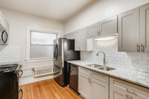 Newly remodeled kitchen with black stainless steel appliances, grantie countertops, subway tile backsplash.