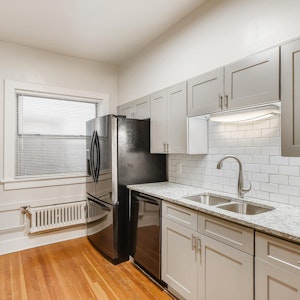 Newly remodeled kitchen with black stainless steel appliances, grantie countertops, subway tile backsplash.