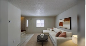 Living room with tile floors and front entry