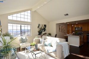 Living room with beautiful window and open concept to kitchen