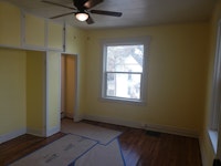Living room. The newly-stained floor temporarily protected until move-in.