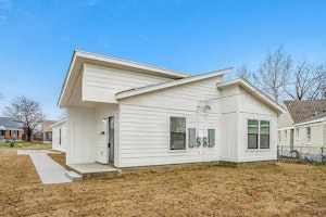 Modern townhouse featuring a well-kept exterior, private driveway, and secure entry—offering residents comfort and peace of mind