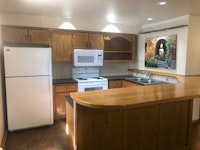 Full size kitchen with HUGE bar and counter top, open to living room