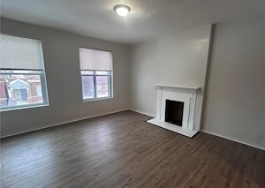 Bright living room with great natural light and decorative fireplace detail